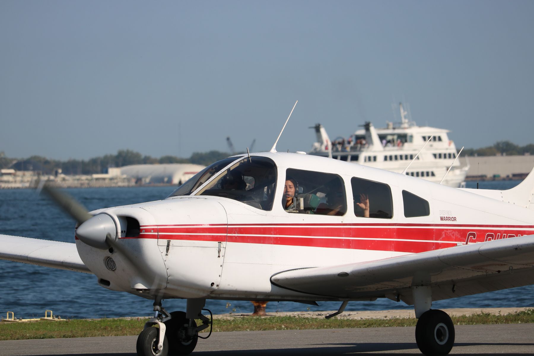 A Piper on the apron at Billy Bishop with the harbour ferry behind