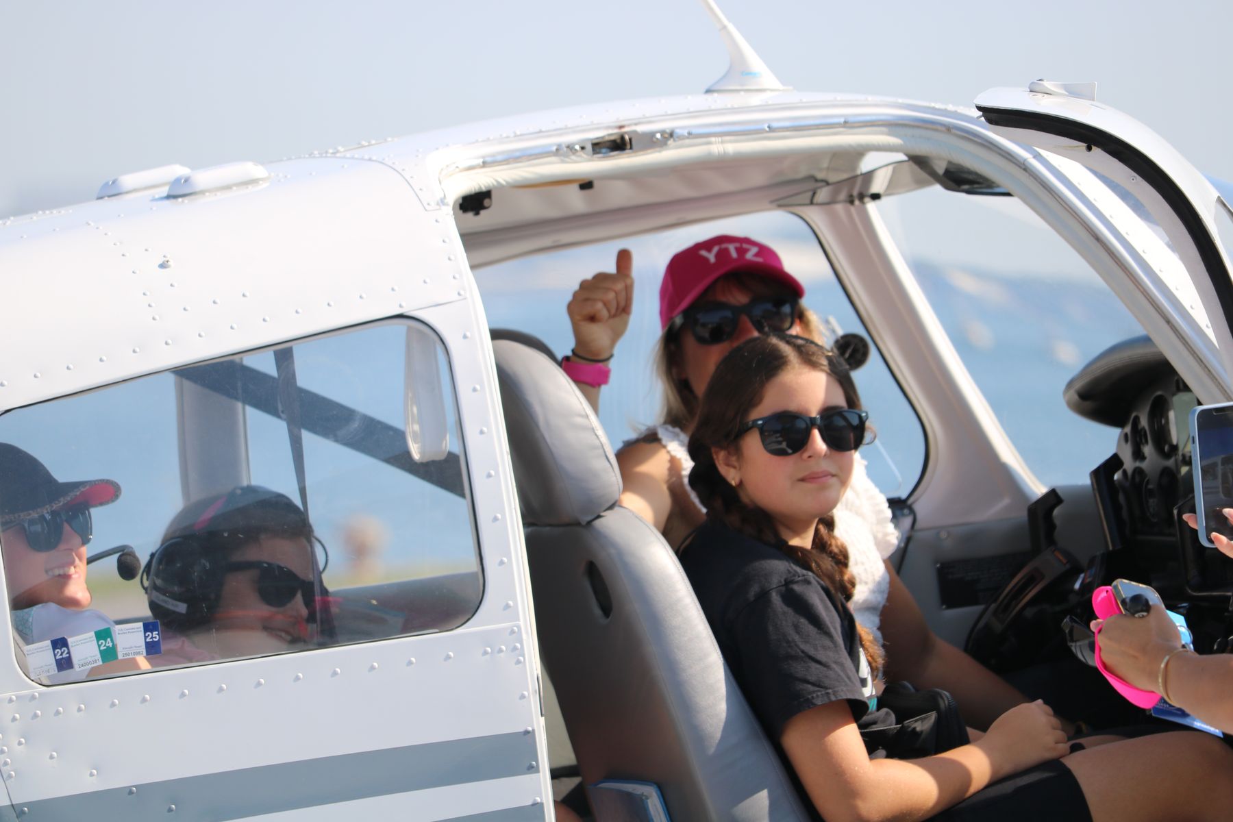 A participant in a Piper on the ramp, giving a thumbs up