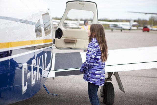 A participant beside a Cessna on the ramp